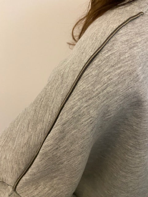 Grey silky pipping on a grey sweatshirt