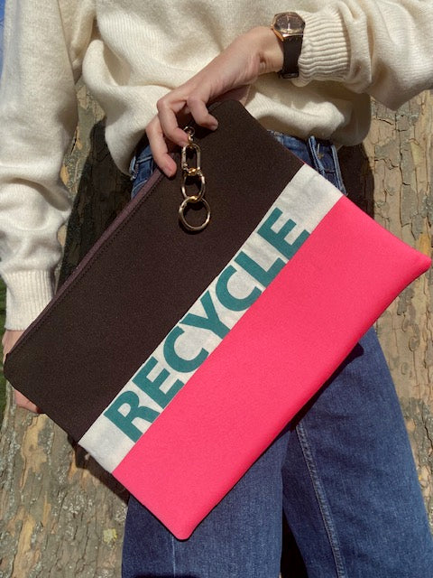 Brown and pink scuba clutch bag with 'Recycle' text