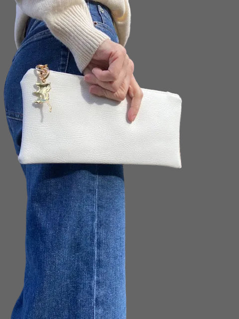 White  faux leather pouch with gold animal print charm