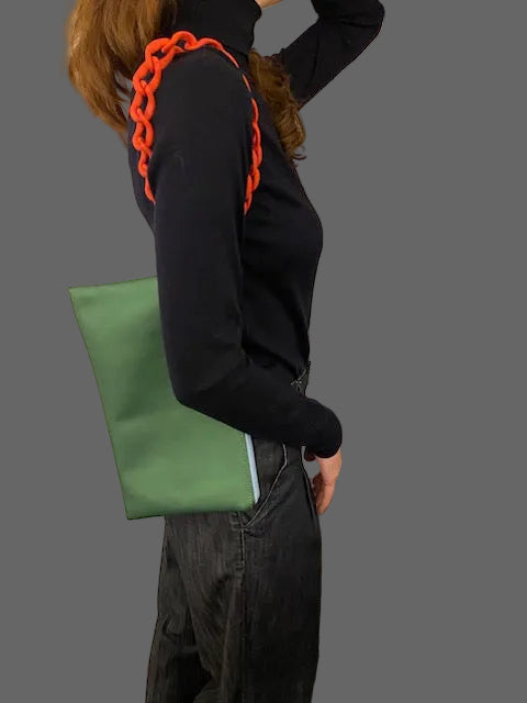 Double faced green/baby pink clutch bag with a chain holder