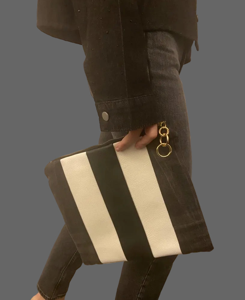 Black, grey denim  and white striped clutch with a gold keychain.