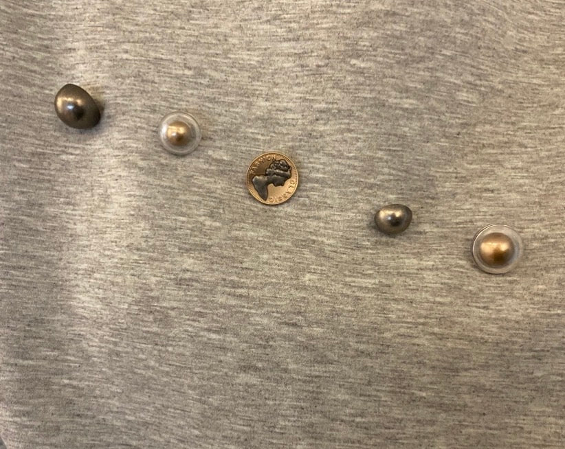 Designed buttons on a grey sweatshirt
